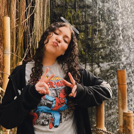 sister posing in front of waterfall