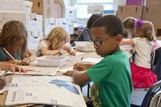 student reading book and writing notes