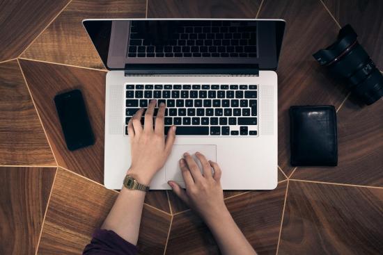 Hands typing on laptop 