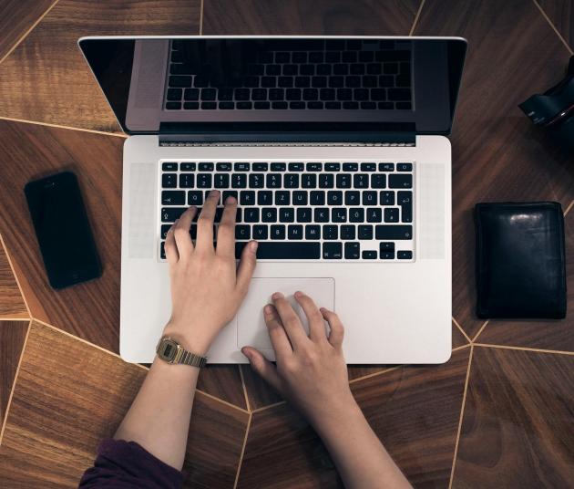 Hands typing on laptop 